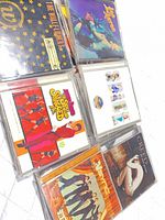 Six jewel-case CDs including The Wallflowers, Lifehouse, Austin Powers soundtrack, Sex and the City soundtrack, *NSYNC and one unidentified