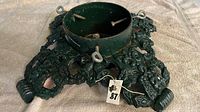 top view of cast iron Christmas tree stand showing ornate base and reservoir