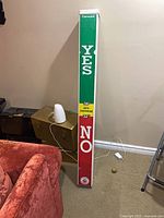 Full view of resin carnival height requirement post showing YES / NO markings