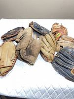All nine gloves laid out on surface showing variety