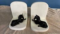 Front view showing both white bookends with black horse figures