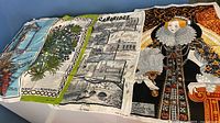 Four tea towels laid out: London scene, herb motif, Cambridge, Elizabeth I