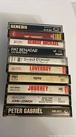 Stack of cassette spines showing artist and album titles
