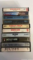 Stack of 10 cassette spines showing artist and album titles