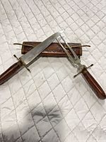 Knife and fork resting on sheath showing full view