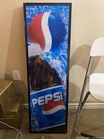 Front view of Pepsi sign unlit showing logo and splash graphic