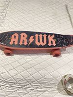 Top view showing full skateboard deck with graphics