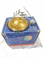 Ornament on box showing satellite and reindeer detail