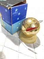 Globe on base with box in background