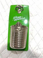 Front view showing entire Steam Whistle magnetic opener with cap catcher