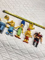All six figures laid out with tape measure
