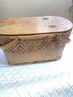 Full view of woven picnic basket with lid and handles