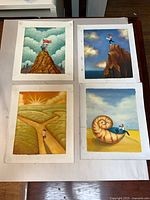 Group shot of all four oil paintings laid out on table