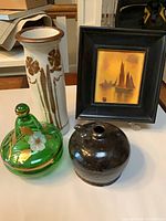 Group shot of all four items: soy pot, green covered bowl, pottery vase, framed sailboat art