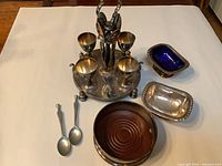 Full lot overview: egg cruet, coaster, salt cellar, tray, spoons