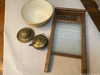 Full group view showing washboard, ceramic bowl, brass kettle, brass inkwell