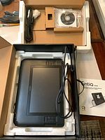 Tablet in foam packaging with cable harness, driver CD and manual