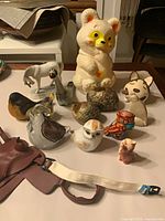 Group shot of entire assortment including blow mold piggy bank and figurines