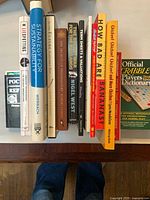 Row of nine books standing upright on tabletop