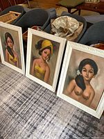 All three framed Hardy oil portraits grouped on floor
