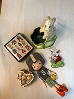 Group shot showing all items: rabbit candy holder, football doll, ornament box, seashell trinket box closed