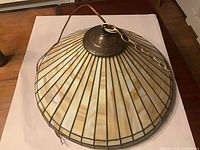 Full view of dome slag glass pendant showing glass panels and chain