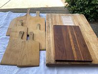 Group shot showing butcher-block slab, striped board, five maple paddle boards