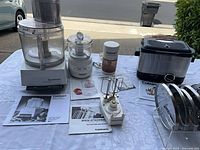 Group shot showing all Cuisinart appliances and manuals on table