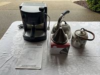 Group shot of espresso machine, manual, dripper with box, kettle, teapot