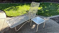 chaise lounge and side table on patio