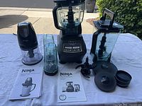 Complete Ninja Mega Kitchen System with motor base, pitchers, cups, blades, lids, manuals