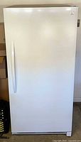 Front view of white Kenmore upright freezer