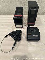 Two Sony SRS-50 speakers, Sony WM-EX102 Walkman, earphones