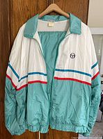 Front of Sergio Tacchini track suit jacket showing color blocking, logo, zipper