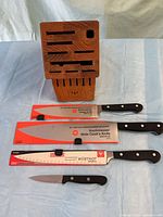 Three packaged knives, one paring knife and wood block