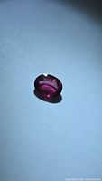 Front view of oval rubelite tourmaline showing color and cut