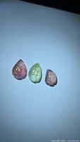 Three leaf-cut tourmaline gemstones grouped