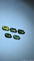 Five octagon cut sapphires displaying green-yellow tones