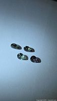 Four pear-cut multicolour sapphires on white background