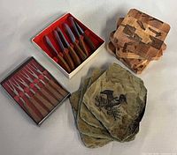 Boxed teak handle cheese spreaders, boxed appetizer forks, two stacks of coasters