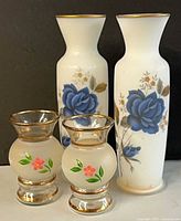 Front view of all four vases showing designs and relative sizes