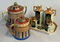 Full view of cruet set and two sugar bowls