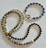 Necklace and bracelet laid flat showing overall design and clasps