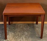 Front view of teak side table showing top and legs
