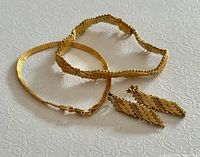 Bracelets and earrings grouped to show styles and finish