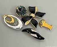 Front view of five brooches