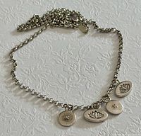 Full view of sterling silver necklace with three charms