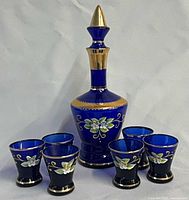 full decanter with stopper and six glasses front view