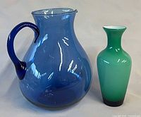 blue glass pitcher and green vase front view