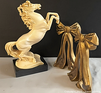 Horse statue and two brass bows group shot